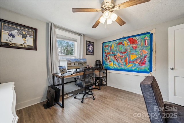 office area with ceiling fan, a textured ceiling, and light wood-type flooring