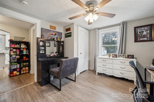 office space featuring ceiling fan, a textured ceiling, and light wood-type flooring