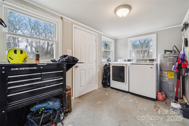 washroom featuring electric water heater and washer and dryer