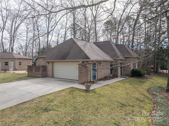 single story home with a garage, driveway, a front yard, and brick siding