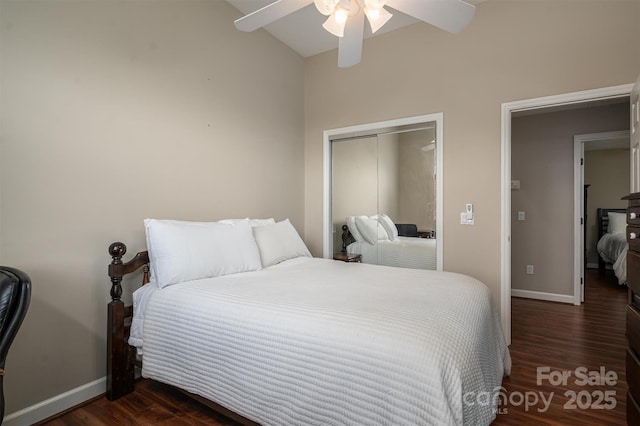 bedroom featuring a closet, dark wood-style flooring, ceiling fan, and baseboards