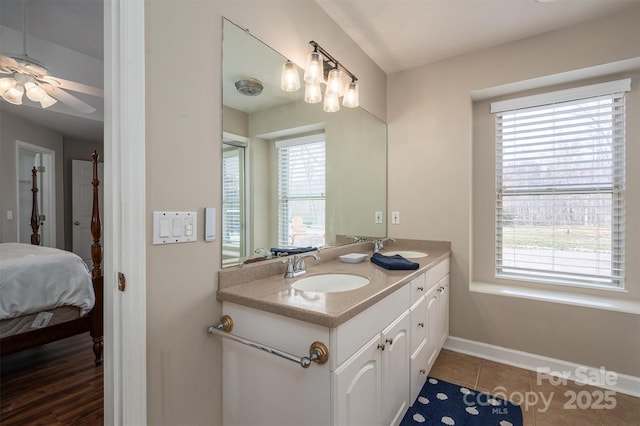 ensuite bathroom with plenty of natural light, double vanity, a sink, and ensuite bathroom