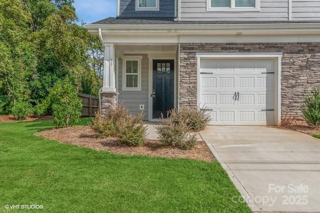 doorway to property with a garage and a yard