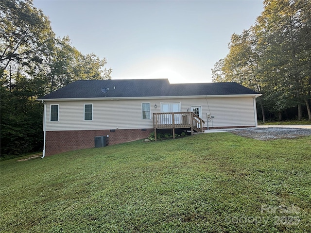 back of house featuring a lawn, central air condition unit, and a deck