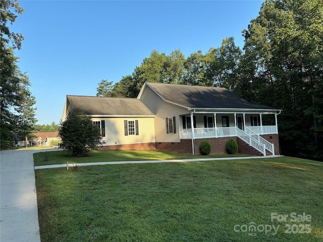 view of front facade with covered porch and a front lawn