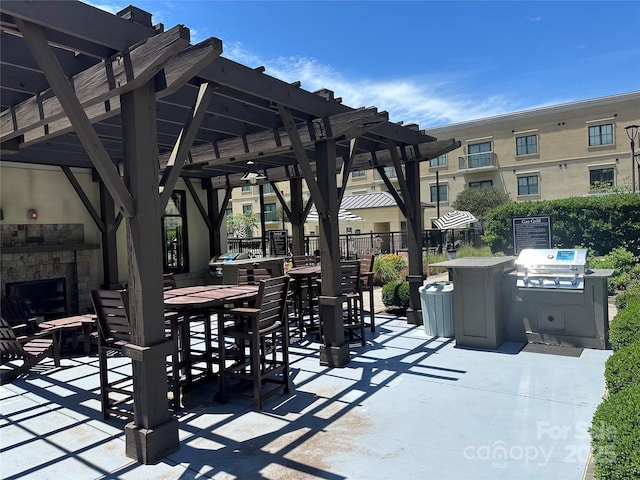 view of patio featuring grilling area and a fireplace