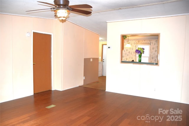 empty room with dark hardwood / wood-style flooring and ceiling fan