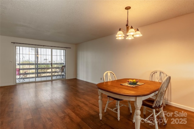 dining space with a chandelier, a textured ceiling, and dark hardwood / wood-style flooring