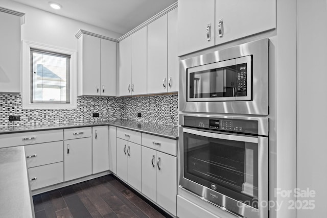 kitchen featuring white cabinetry, appliances with stainless steel finishes, and backsplash