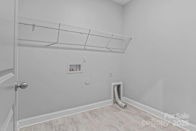 laundry room featuring gas dryer hookup, hookup for a washing machine, electric dryer hookup, and light wood-type flooring