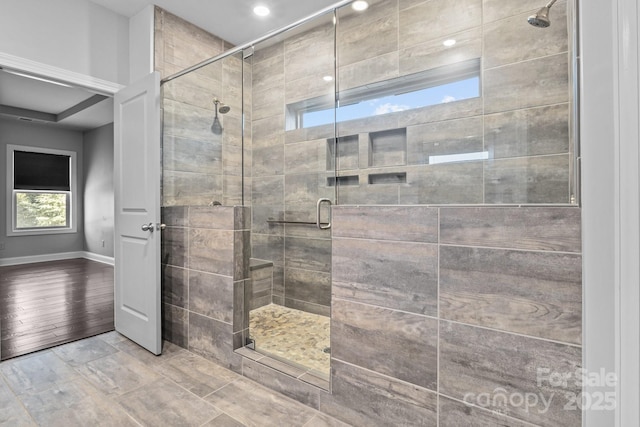 bathroom featuring a shower with shower door