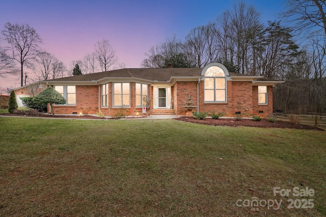 ranch-style house featuring a lawn