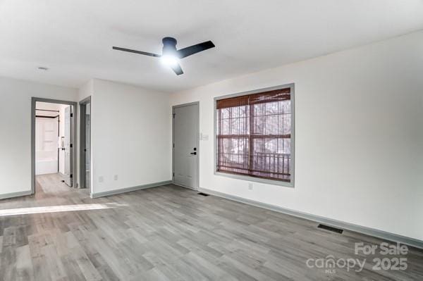 unfurnished room with ceiling fan and light hardwood / wood-style floors