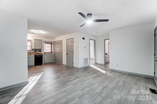 unfurnished living room with ceiling fan and light hardwood / wood-style flooring