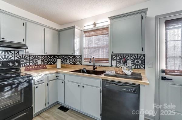 kitchen with gray cabinets, tasteful backsplash, sink, and black appliances