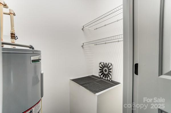 laundry area with water heater