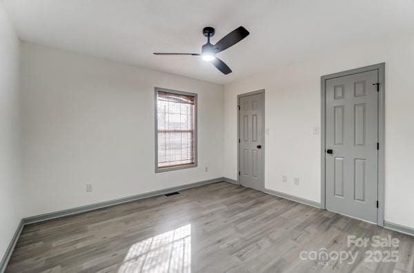 unfurnished bedroom featuring light hardwood / wood-style flooring and ceiling fan