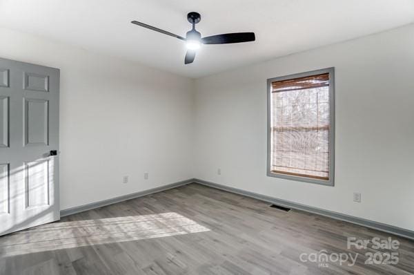 spare room with ceiling fan and light hardwood / wood-style floors