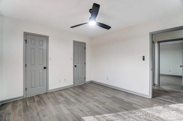 unfurnished bedroom featuring ceiling fan and light hardwood / wood-style floors