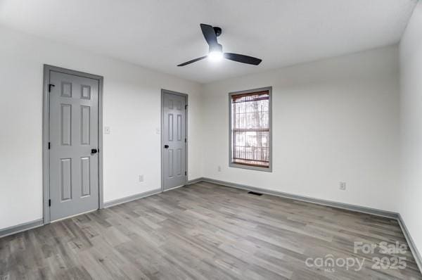 unfurnished bedroom featuring ceiling fan and light wood-type flooring