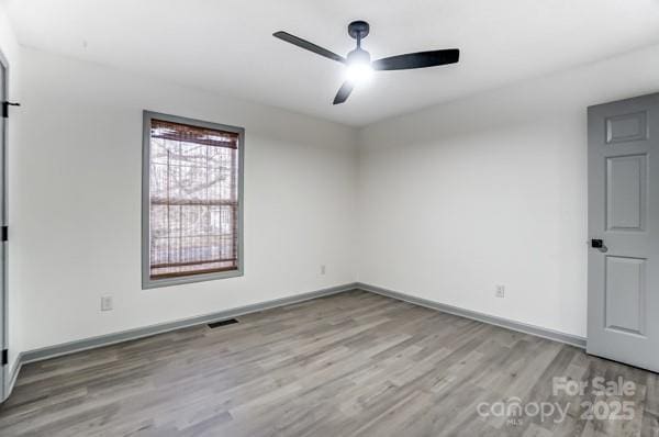 unfurnished room with light hardwood / wood-style flooring and ceiling fan