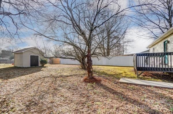 view of yard with a deck and a shed