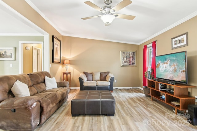 living room with ceiling fan, ornamental molding, and light hardwood / wood-style floors