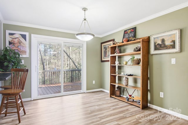 dining space with crown molding and light wood-type flooring