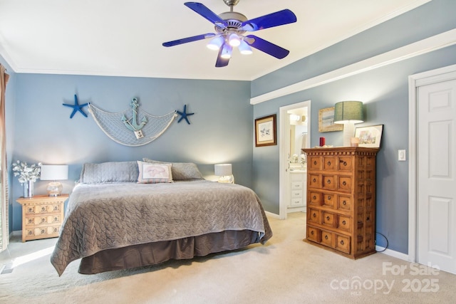 carpeted bedroom with crown molding, ensuite bath, and ceiling fan