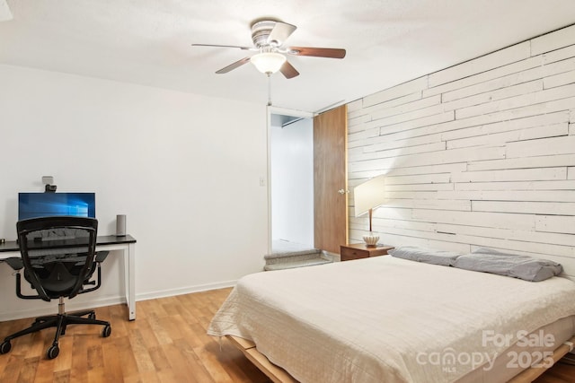 bedroom with ceiling fan and light wood-type flooring