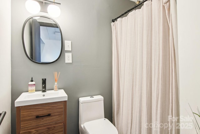 bathroom with vanity, toilet, and a shower with shower curtain