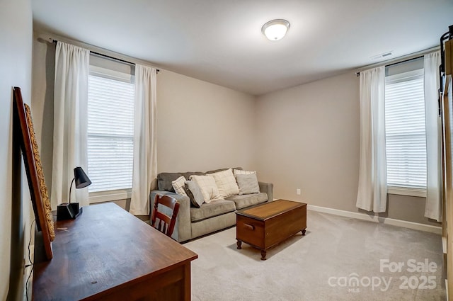 living room with light colored carpet and a healthy amount of sunlight