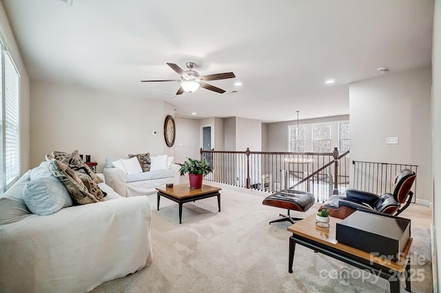 living room featuring light colored carpet and ceiling fan