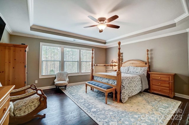 bedroom with dark wood-type flooring, ceiling fan, crown molding, and a raised ceiling