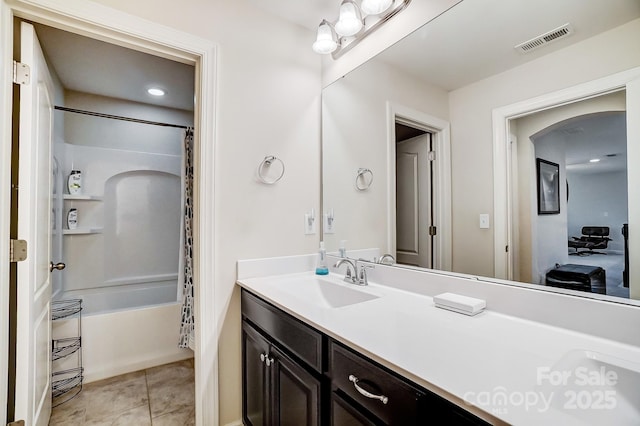 bathroom with tile patterned flooring, vanity, and shower / tub combo with curtain