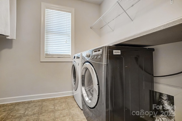 washroom with washing machine and dryer and light tile patterned floors