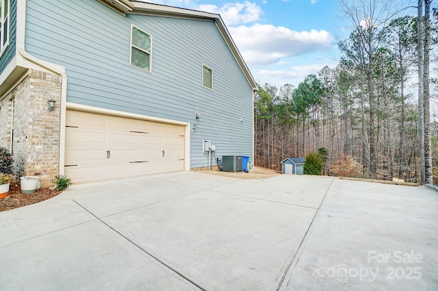 view of property exterior with cooling unit and a garage