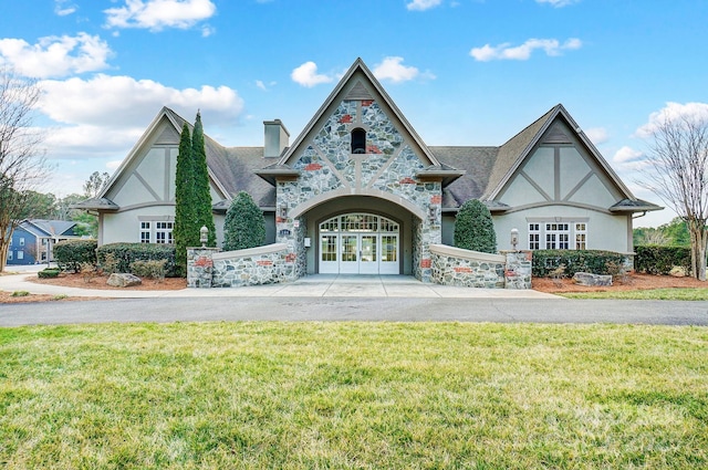 view of front facade with french doors and a front yard