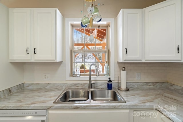 kitchen featuring white cabinetry, dishwasher, and sink