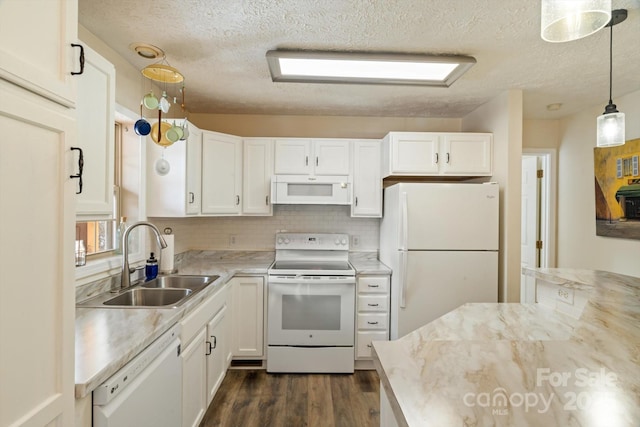 kitchen featuring sink, white appliances, white cabinetry, hanging light fixtures, and dark hardwood / wood-style flooring