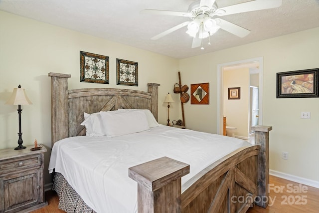 bedroom with ensuite bath, light hardwood / wood-style flooring, a textured ceiling, and ceiling fan