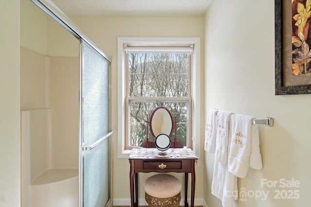 bathroom with a shower with shower door