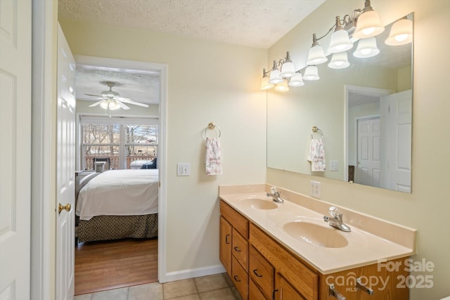 bathroom with ceiling fan, tile patterned floors, a textured ceiling, and vanity