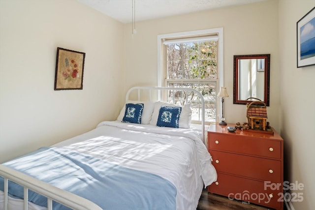 bedroom with dark wood-type flooring