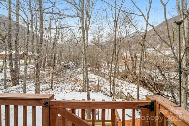 yard covered in snow featuring a mountain view