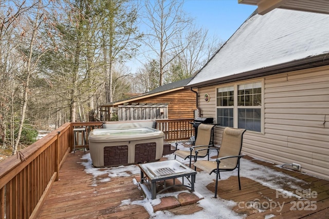 snow covered deck with a hot tub