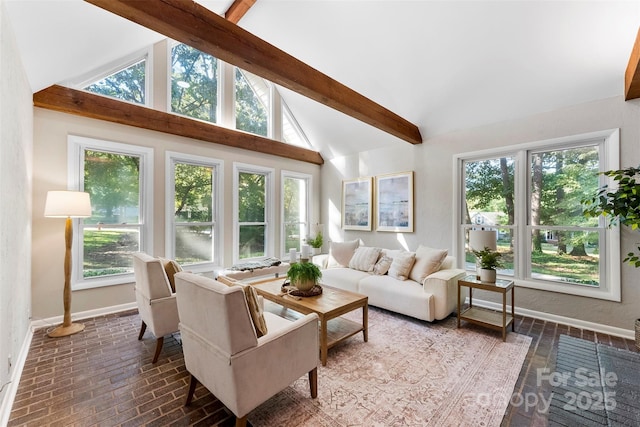 sunroom with lofted ceiling with beams and a wealth of natural light