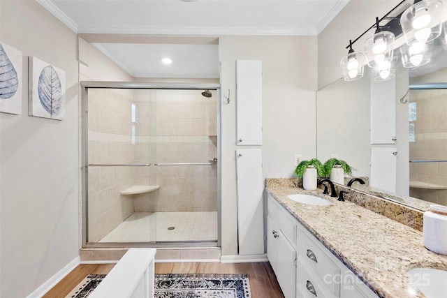 bathroom featuring vanity, hardwood / wood-style floors, ornamental molding, and walk in shower