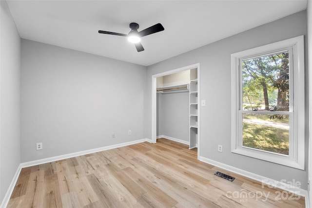 unfurnished bedroom with a closet, ceiling fan, and light wood-type flooring