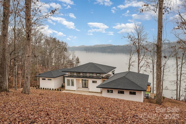 view of front of house featuring a patio area and a water and mountain view